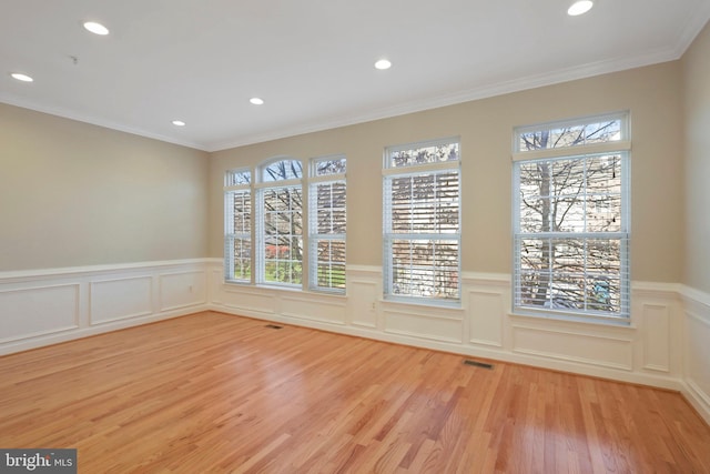 unfurnished room featuring light hardwood / wood-style flooring and ornamental molding