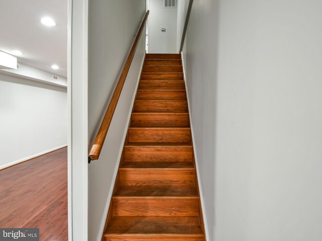 staircase featuring wood-type flooring