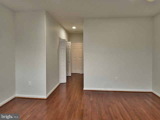 spare room featuring dark hardwood / wood-style flooring