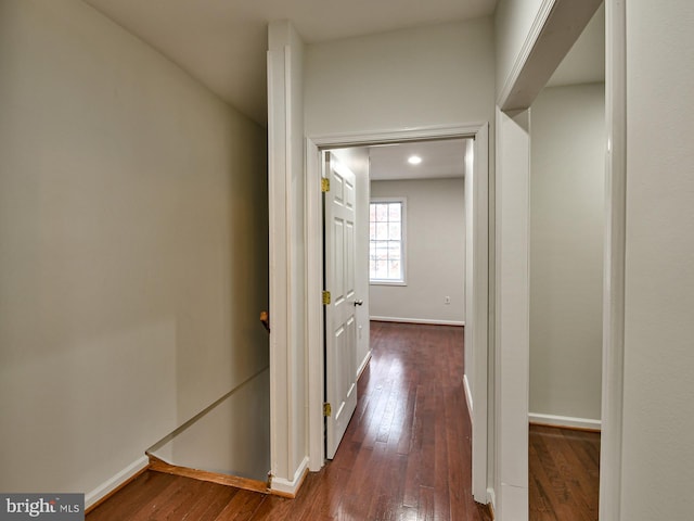 hallway with dark hardwood / wood-style flooring