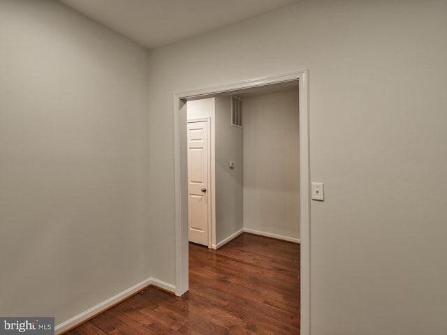 hallway with dark hardwood / wood-style flooring