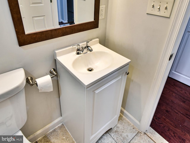 bathroom with vanity, wood-type flooring, and toilet