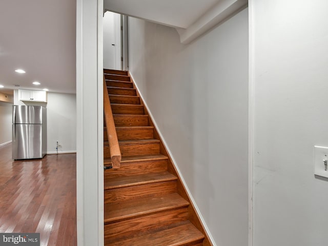 stairs featuring hardwood / wood-style floors