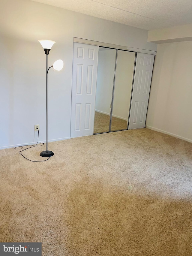 unfurnished bedroom featuring carpet flooring and a textured ceiling