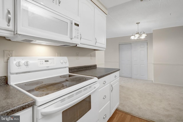 5911 Edsall Rd Unit 1107, Alexandria, VA 22304 - kitchen with white appliances, white cabinets, dark countertops, a chandelier, and light wood-style flooring