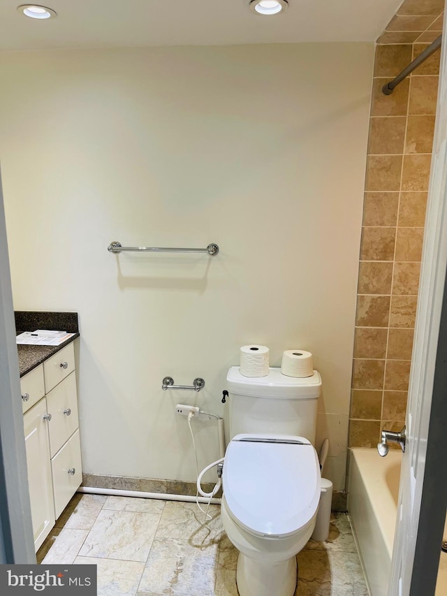 full bathroom featuring vanity, toilet, and tiled shower / bath