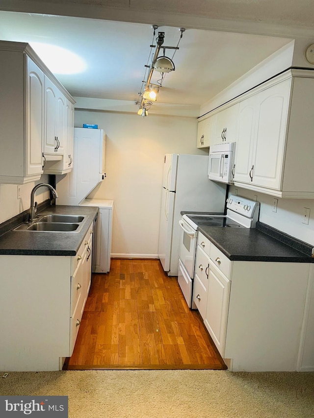 kitchen with white cabinetry, white appliances, sink, and light hardwood / wood-style flooring