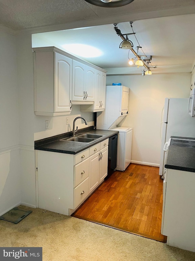 kitchen with white cabinets, light hardwood / wood-style floors, white appliances, and sink