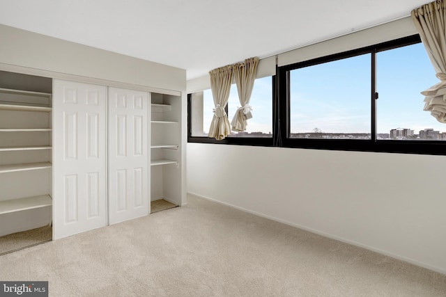 5911 Edsall Rd Unit 1107, Alexandria, VA 22304 - unfurnished bedroom featuring multiple windows, carpet floors, a closet, and baseboards
