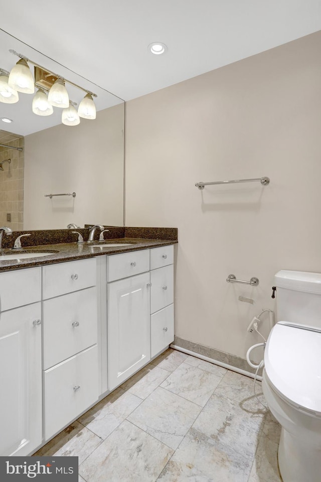 5911 Edsall Rd Unit 1107, Alexandria, VA 22304 - bathroom featuring double vanity, toilet, marble look tile flooring, baseboards, and recessed lighting