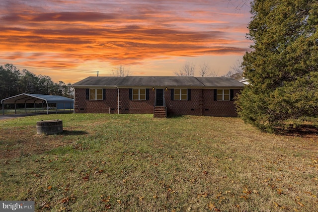 view of front of house featuring a yard and a carport