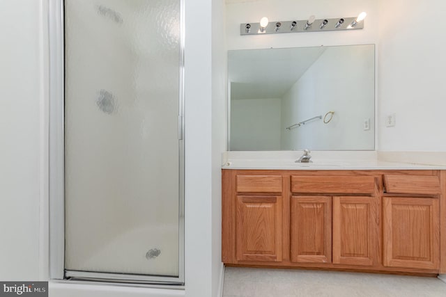 bathroom featuring vanity and a shower with shower door