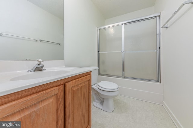 full bathroom with vanity, a textured ceiling, toilet, and bath / shower combo with glass door