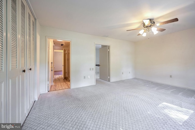 unfurnished bedroom with light carpet and ceiling fan