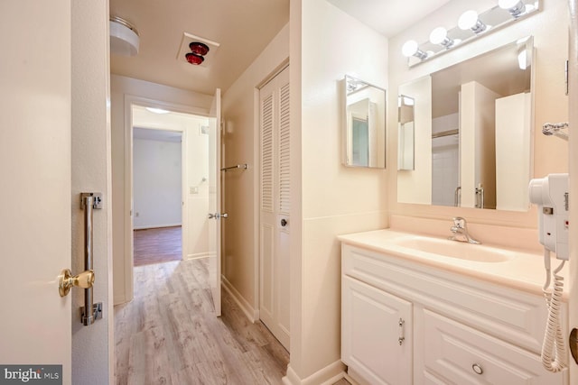 bathroom with vanity and hardwood / wood-style flooring