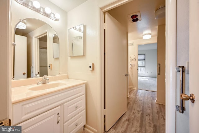 bathroom featuring vanity, a textured ceiling, and hardwood / wood-style flooring