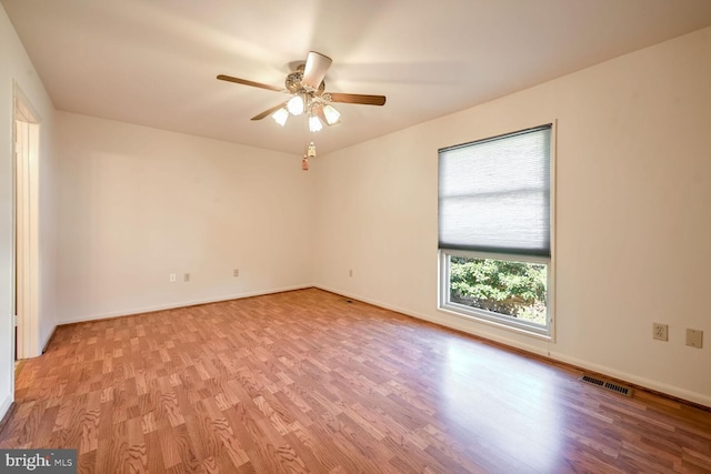 spare room featuring light wood-type flooring and ceiling fan