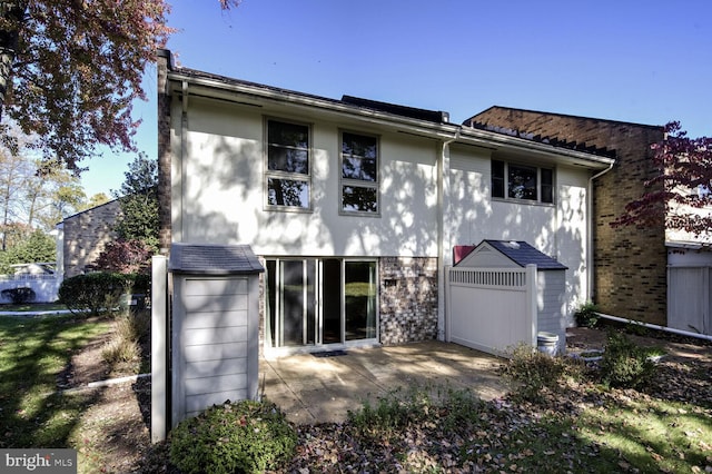 back of property with a patio