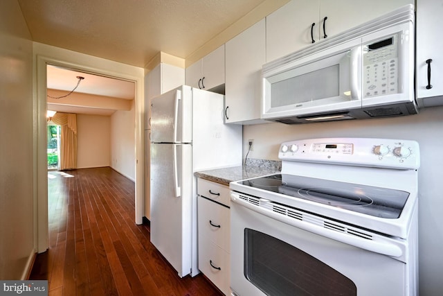 kitchen featuring white appliances, dark hardwood / wood-style floors, and white cabinetry