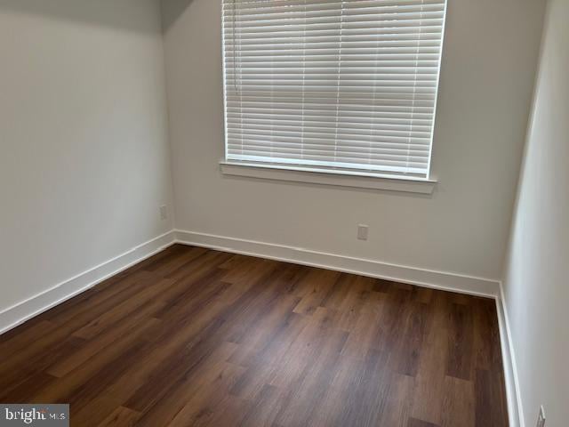 spare room with dark hardwood / wood-style floors