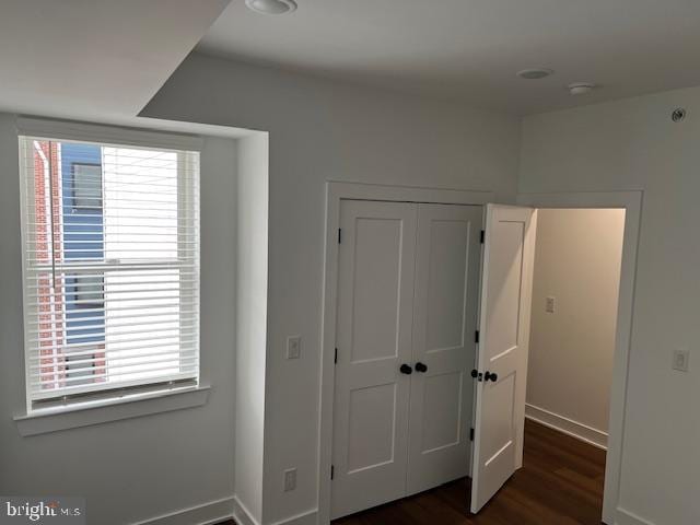 unfurnished bedroom featuring dark hardwood / wood-style flooring