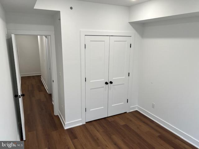 hallway featuring dark wood-type flooring