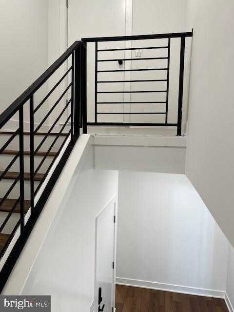 stairs featuring hardwood / wood-style floors