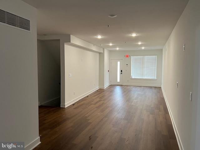 unfurnished room with dark hardwood / wood-style flooring