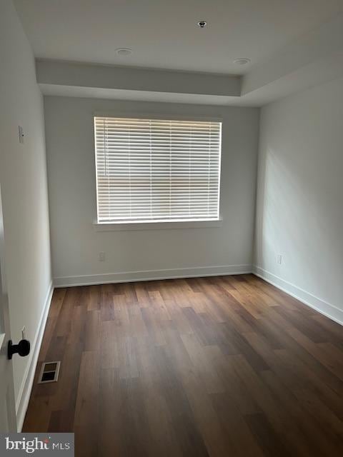 unfurnished room featuring dark hardwood / wood-style flooring