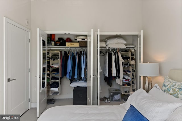 bedroom with multiple closets and carpet