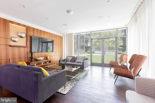 525 Water St SW Unit 326, Washington, DC 20024 - living room featuring healthy amount of natural light, a wall of windows, wood finished floors, wood walls, and french doors
