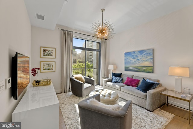 525 Water St SW Unit 326, Washington, DC 20024 - living room featuring a chandelier, wood finished floors, and baseboards