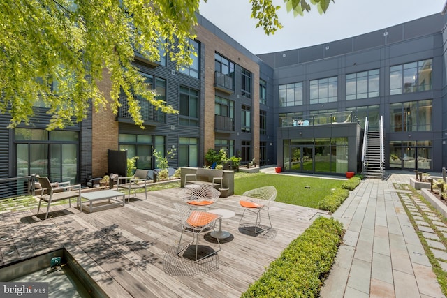 view of home's community featuring an outdoor hangout area and a deck