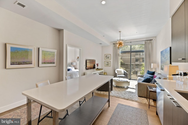 dining area featuring a chandelier and light hardwood / wood-style floors