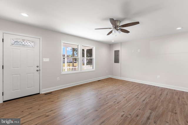 foyer entrance with electric panel, hardwood / wood-style flooring, and ceiling fan