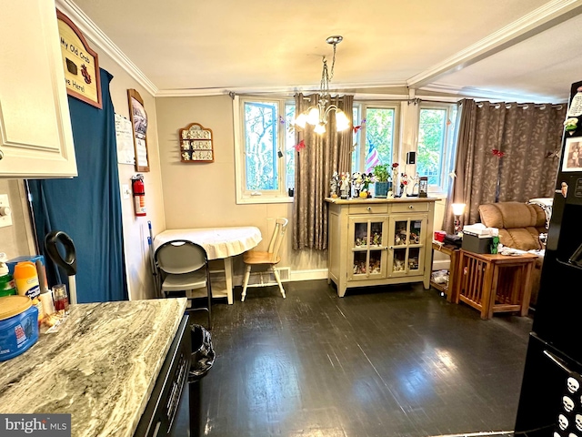 miscellaneous room with dark wood-type flooring, an inviting chandelier, and crown molding