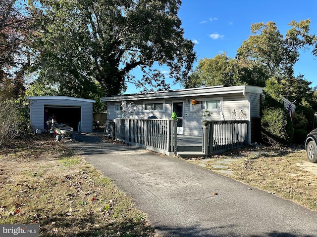 view of front of house with a garage and an outdoor structure