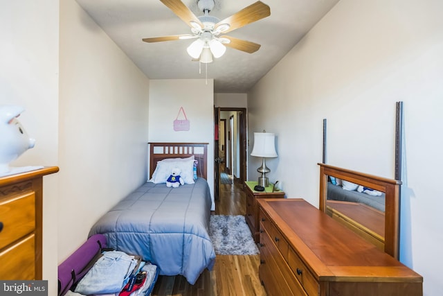 bedroom with ceiling fan and dark wood-type flooring