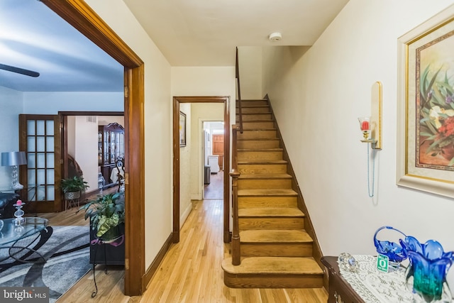 staircase with wood-type flooring