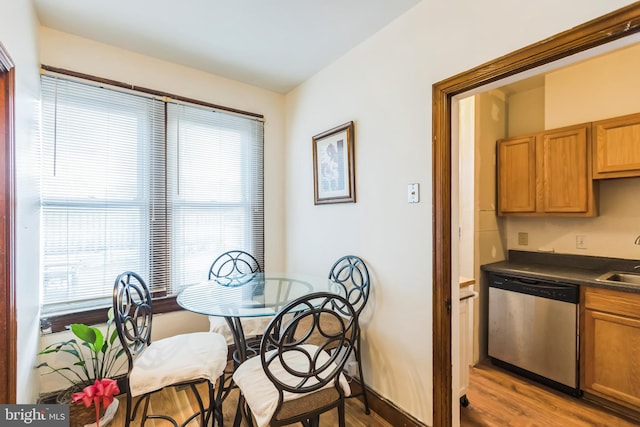 dining space featuring light hardwood / wood-style flooring and sink