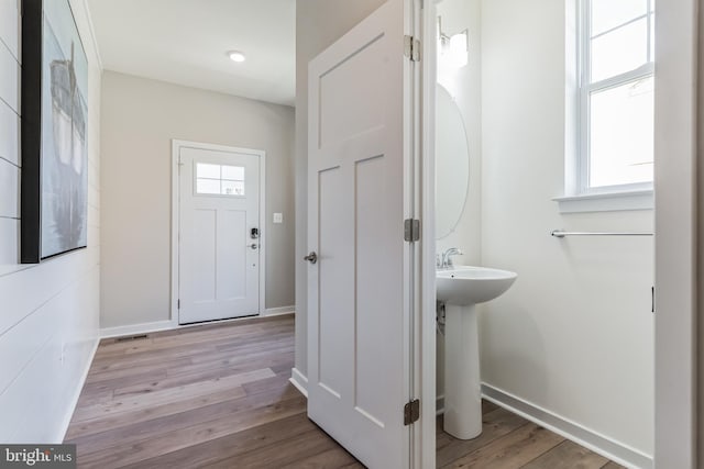 foyer entrance with a wealth of natural light and light hardwood / wood-style flooring