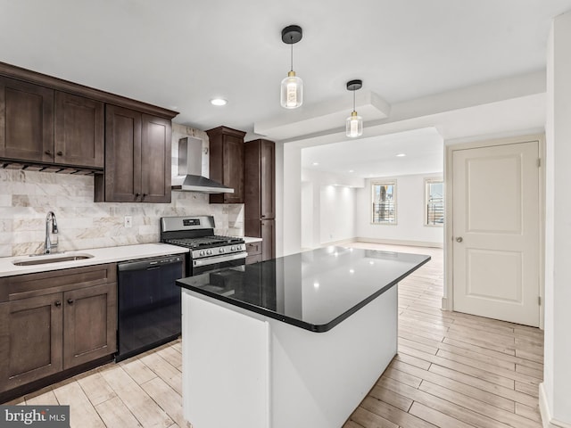 kitchen featuring stainless steel range with gas stovetop, sink, wall chimney range hood, light wood-type flooring, and black dishwasher