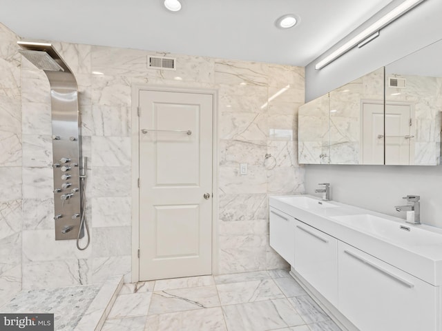 bathroom featuring tile walls, vanity, and a tile shower