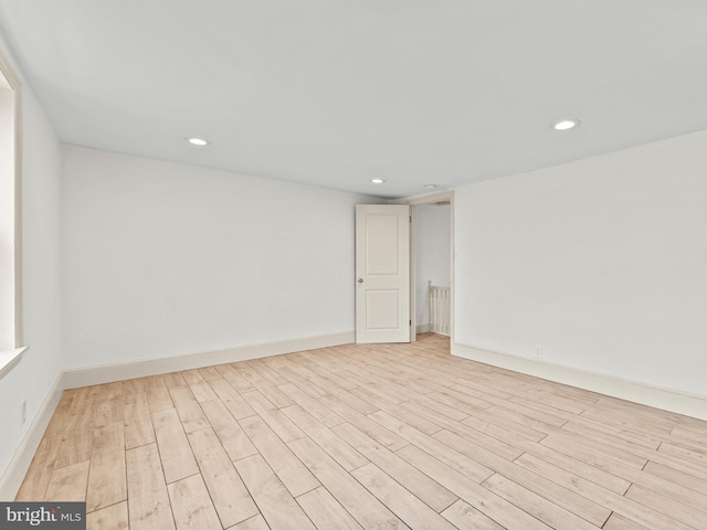 unfurnished room with light wood-type flooring