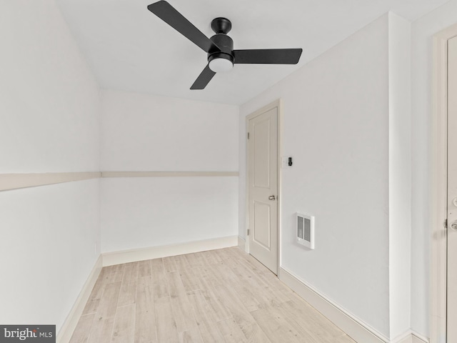 spare room featuring ceiling fan, wood-type flooring, and heating unit