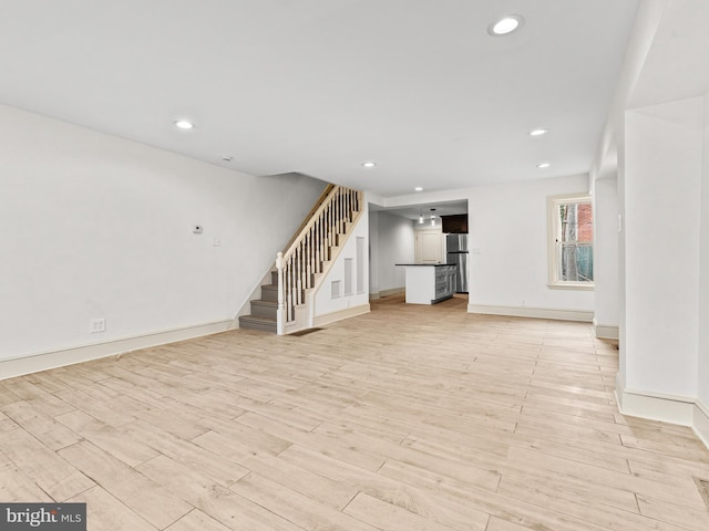 unfurnished living room featuring light wood-type flooring