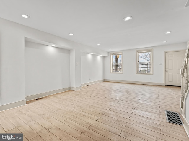 empty room with light hardwood / wood-style flooring