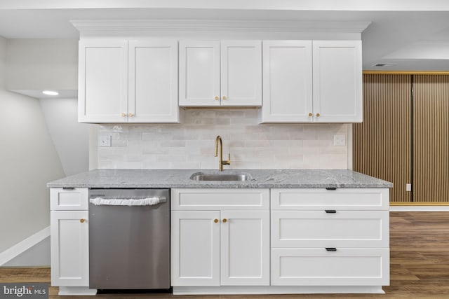 kitchen featuring sink, light stone counters, stainless steel dishwasher, wood-type flooring, and white cabinets