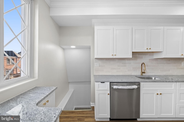 kitchen with light stone counters, sink, stainless steel dishwasher, dark hardwood / wood-style floors, and white cabinetry