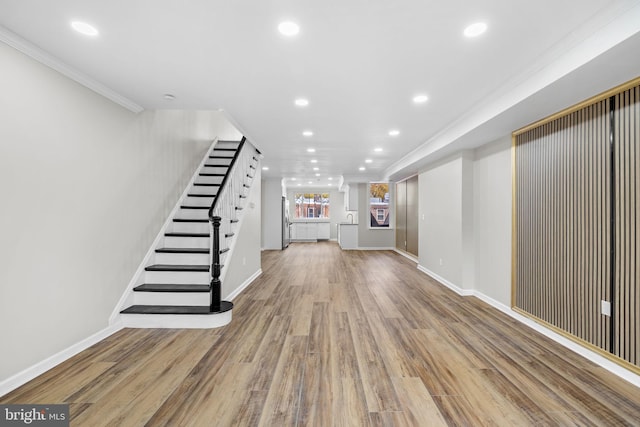 interior space featuring hardwood / wood-style flooring and ornamental molding